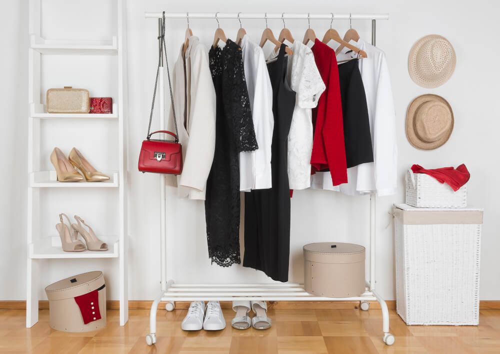 clothes rack with clothes on hangers