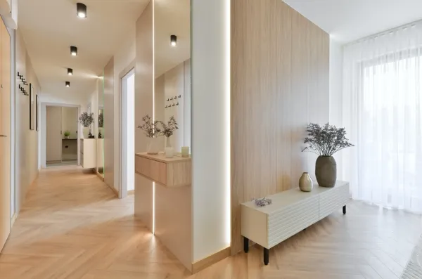 hallway in a home lit up with overhead lights