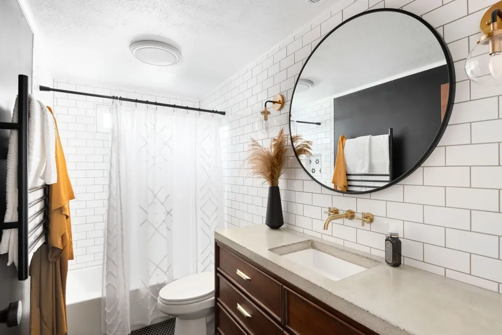 small bathroom with a large mirror over the sink