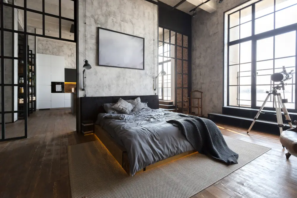 bedroom in a loft with large windows and concrete walls